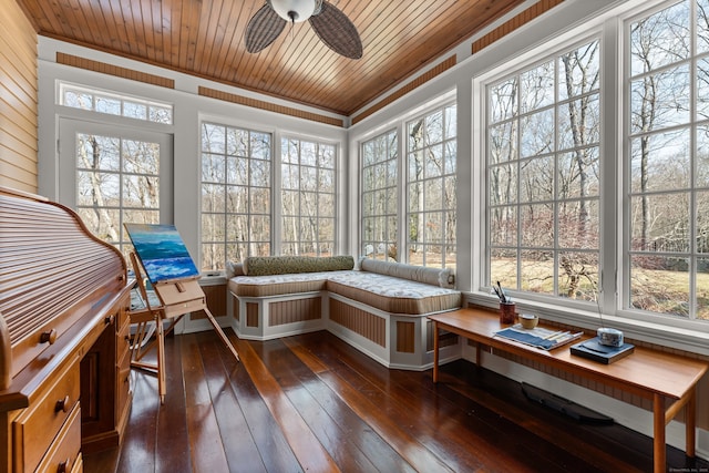 sunroom / solarium featuring wood ceiling and a ceiling fan