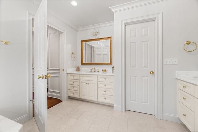 full bathroom with tile patterned floors, baseboards, crown molding, and vanity