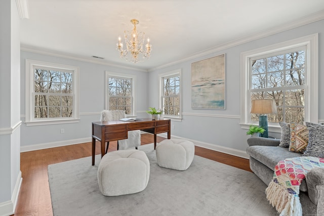 office area featuring wood finished floors, visible vents, baseboards, ornamental molding, and an inviting chandelier