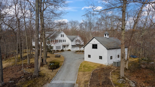 view of front of house featuring driveway and central AC unit