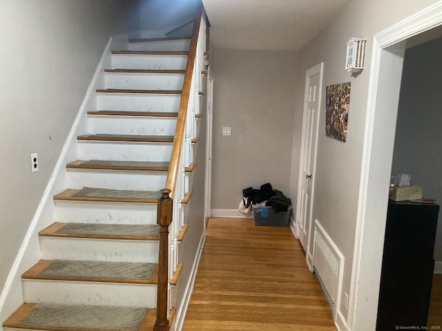 stairway with hardwood / wood-style floors