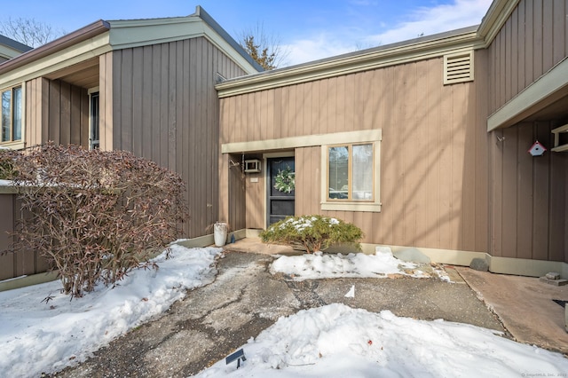 view of snow covered property entrance