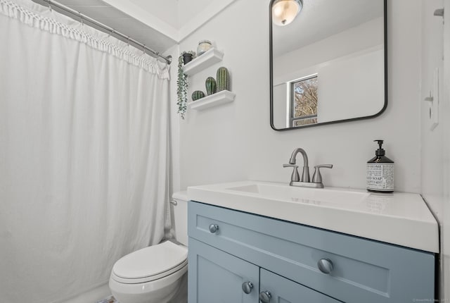 bathroom featuring toilet, vanity, and walk in shower