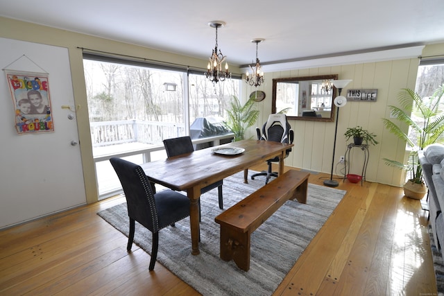 dining area with a chandelier and light hardwood / wood-style floors