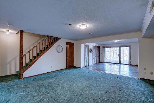 unfurnished living room featuring stairs, baseboards, carpet floors, and a textured ceiling