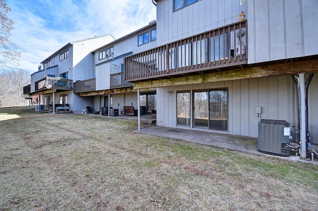 back of property featuring cooling unit and a patio