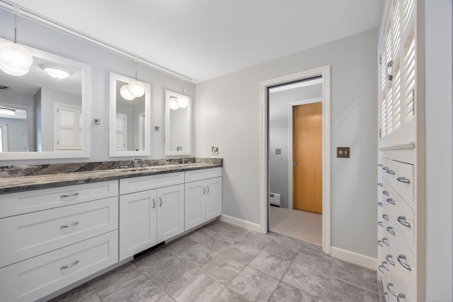 bathroom with vanity and baseboard heating