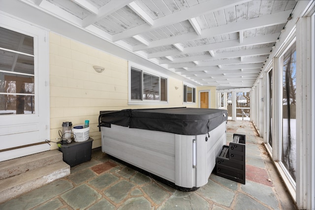 sunroom featuring beamed ceiling