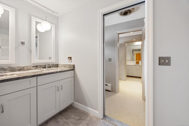 bathroom with vanity and a baseboard heating unit