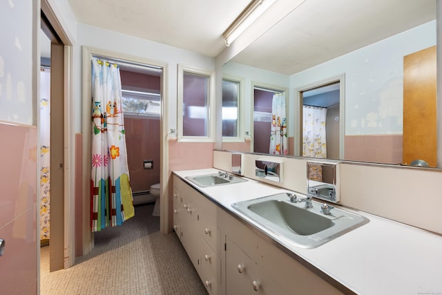 bathroom with vanity, a baseboard heating unit, and toilet