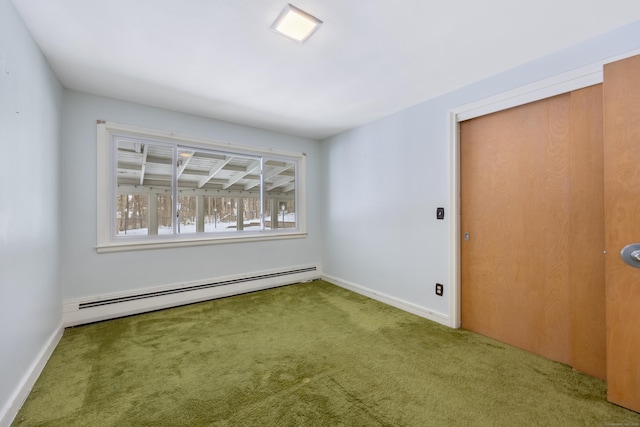 carpeted empty room with baseboard heating