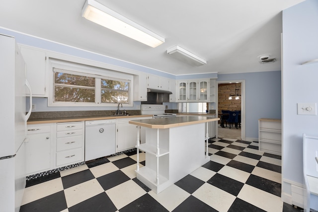 kitchen featuring white cabinetry, white appliances, sink, and a kitchen island