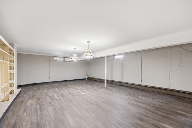 basement with hardwood / wood-style flooring and a healthy amount of sunlight