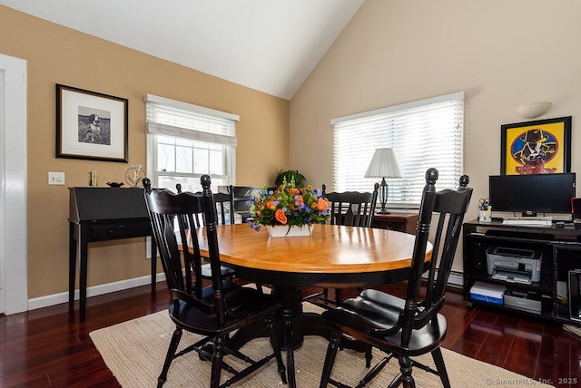 dining space with high vaulted ceiling and dark hardwood / wood-style flooring