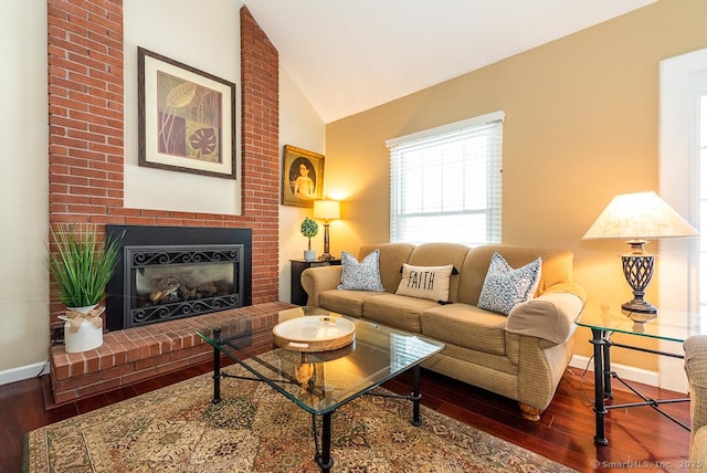 living room with lofted ceiling, hardwood / wood-style floors, and a fireplace