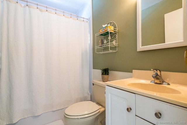 full bathroom with vanity, shower / tub combo with curtain, and toilet