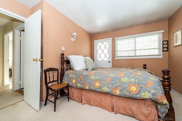 carpeted bedroom featuring lofted ceiling