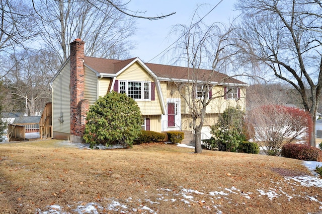 raised ranch with a front yard