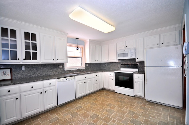 kitchen with sink, white appliances, decorative backsplash, white cabinets, and decorative light fixtures