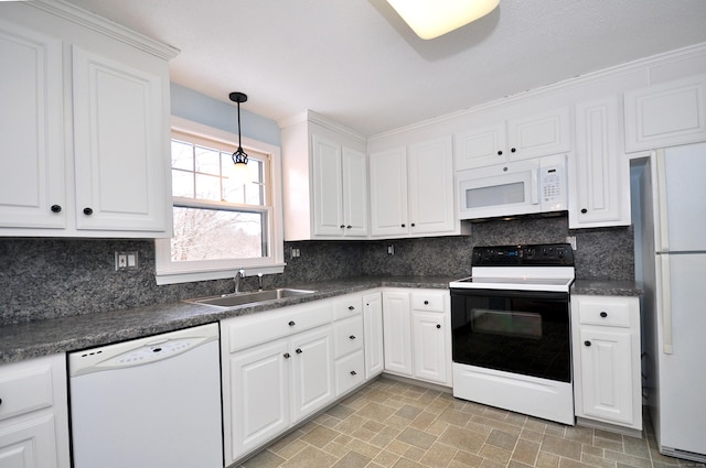 kitchen with tasteful backsplash, sink, white cabinets, and white appliances