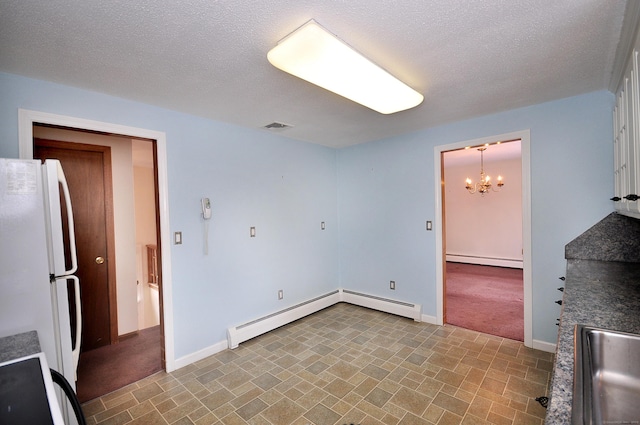 interior space featuring a baseboard radiator, decorative light fixtures, and white fridge