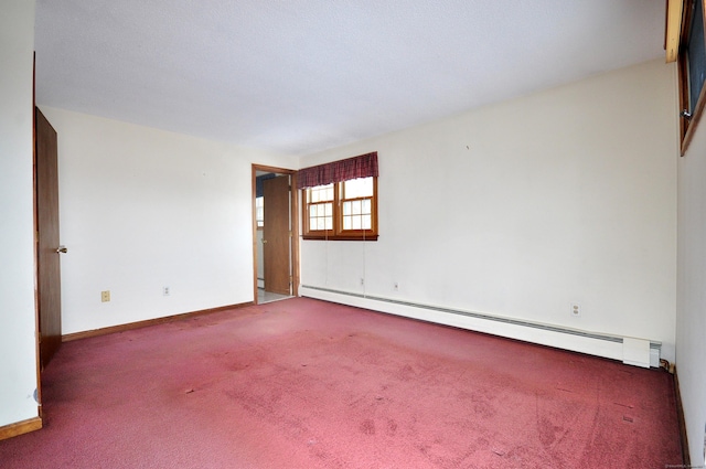 carpeted spare room with baseboard heating