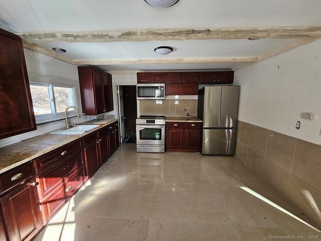 kitchen featuring sink, beam ceiling, stainless steel appliances, tasteful backsplash, and light tile patterned flooring