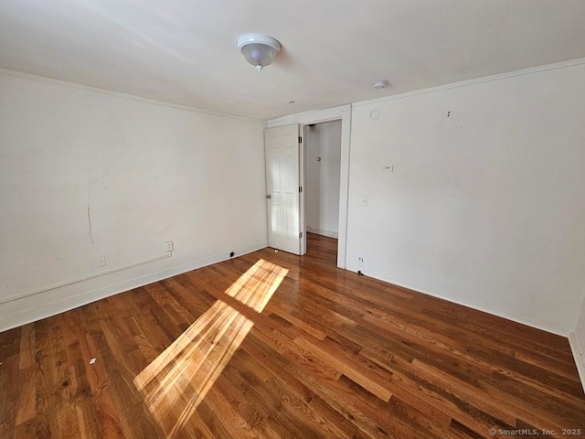 spare room with wood-type flooring