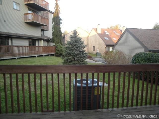 wooden deck with cooling unit and a yard