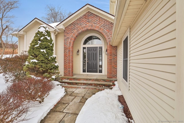 view of snow covered property entrance