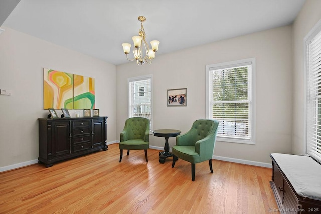 sitting room featuring a chandelier and light hardwood / wood-style floors