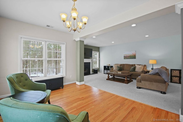 living room featuring hardwood / wood-style flooring and an inviting chandelier