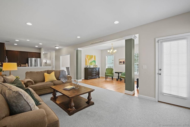 living room with an inviting chandelier and light colored carpet