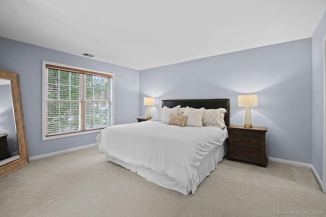 bedroom featuring light carpet