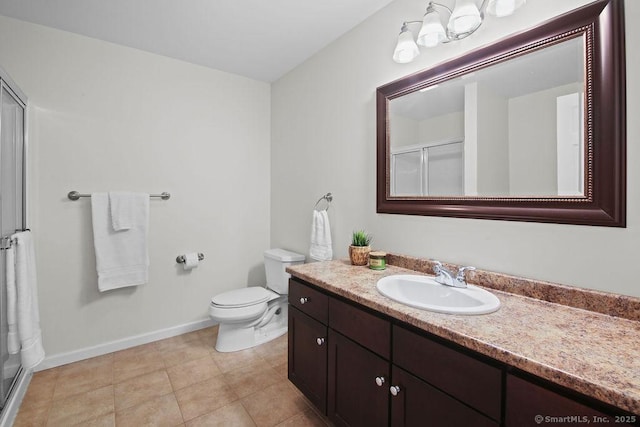 bathroom with vanity, toilet, tile patterned flooring, and a shower with door