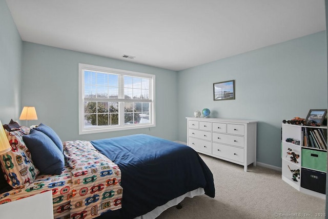 bedroom featuring light colored carpet