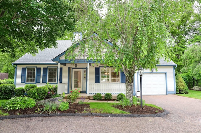 4 Amberly Ln Unit 4, East Lyme, CT 06357 - view of front of house with asphalt driveway, a garage, covered porch, and roof with shingles
