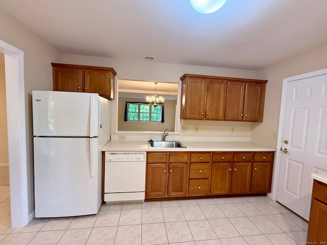 4 Amberly Ln Unit 4, East Lyme, CT 06357 - kitchen with white appliances, a sink, brown cabinetry, a chandelier, and light countertops