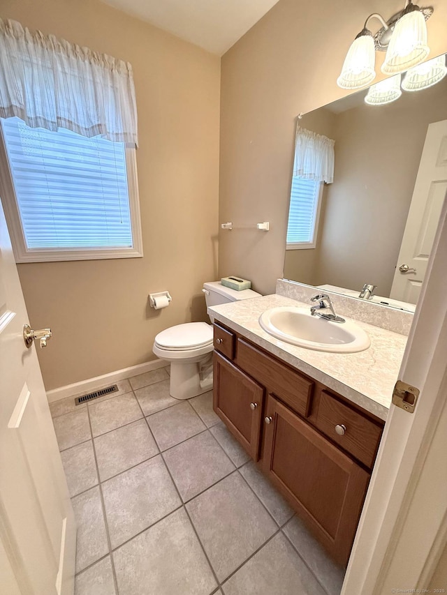 4 Amberly Ln Unit 4, East Lyme, CT 06357 - bathroom featuring tile patterned floors, vanity, toilet, baseboards, and healthy amount of natural light
