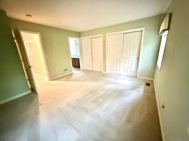 4 Amberly Ln Unit 4, East Lyme, CT 06357 - unfurnished bedroom with two closets, baseboards, and light carpet