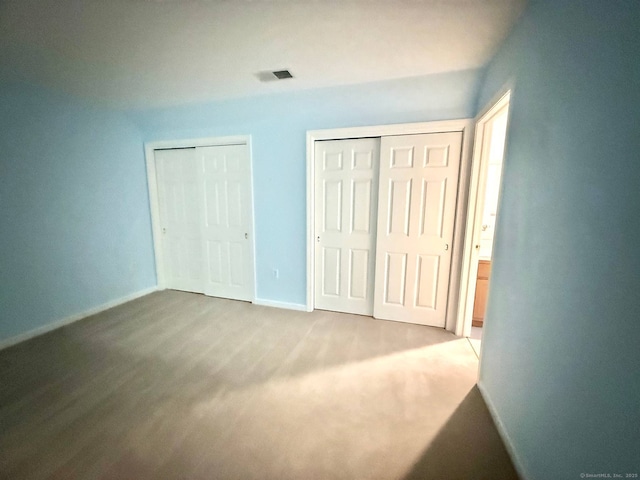 4 Amberly Ln Unit 4, East Lyme, CT 06357 - unfurnished bedroom featuring two closets, baseboards, and carpet