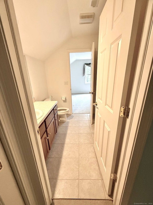 4 Amberly Ln Unit 4, East Lyme, CT 06357 - bathroom with vaulted ceiling, toilet, vanity, and tile patterned floors