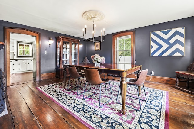 dining room with a notable chandelier, a wealth of natural light, and dark hardwood / wood-style floors