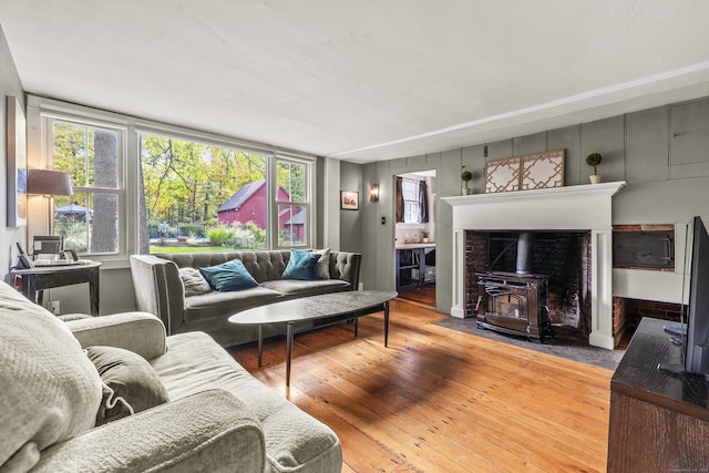 living room with hardwood / wood-style floors and a wood stove