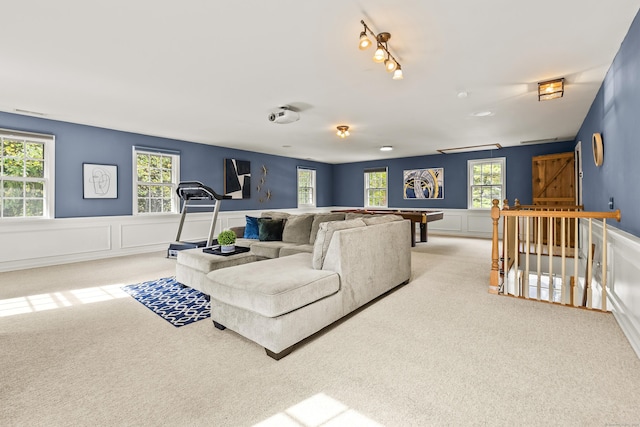 carpeted living room featuring track lighting