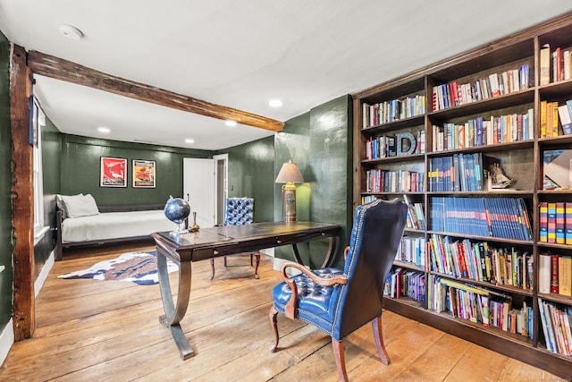 home office with beamed ceiling and light hardwood / wood-style flooring