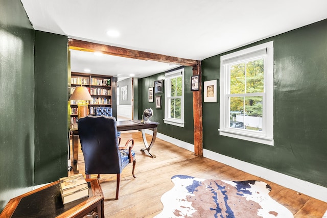 office area with hardwood / wood-style floors and beam ceiling