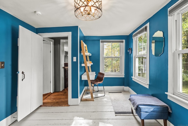 sunroom / solarium featuring an inviting chandelier