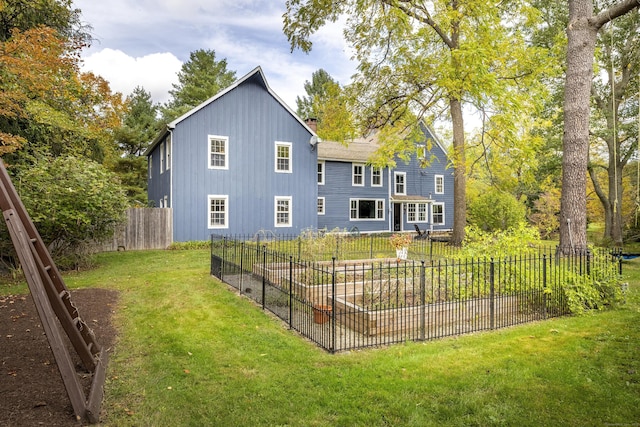 back of property featuring a lawn