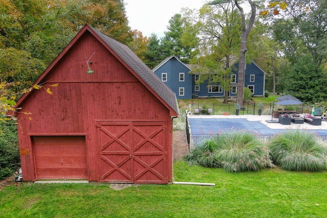 view of outbuilding featuring a garage and a yard